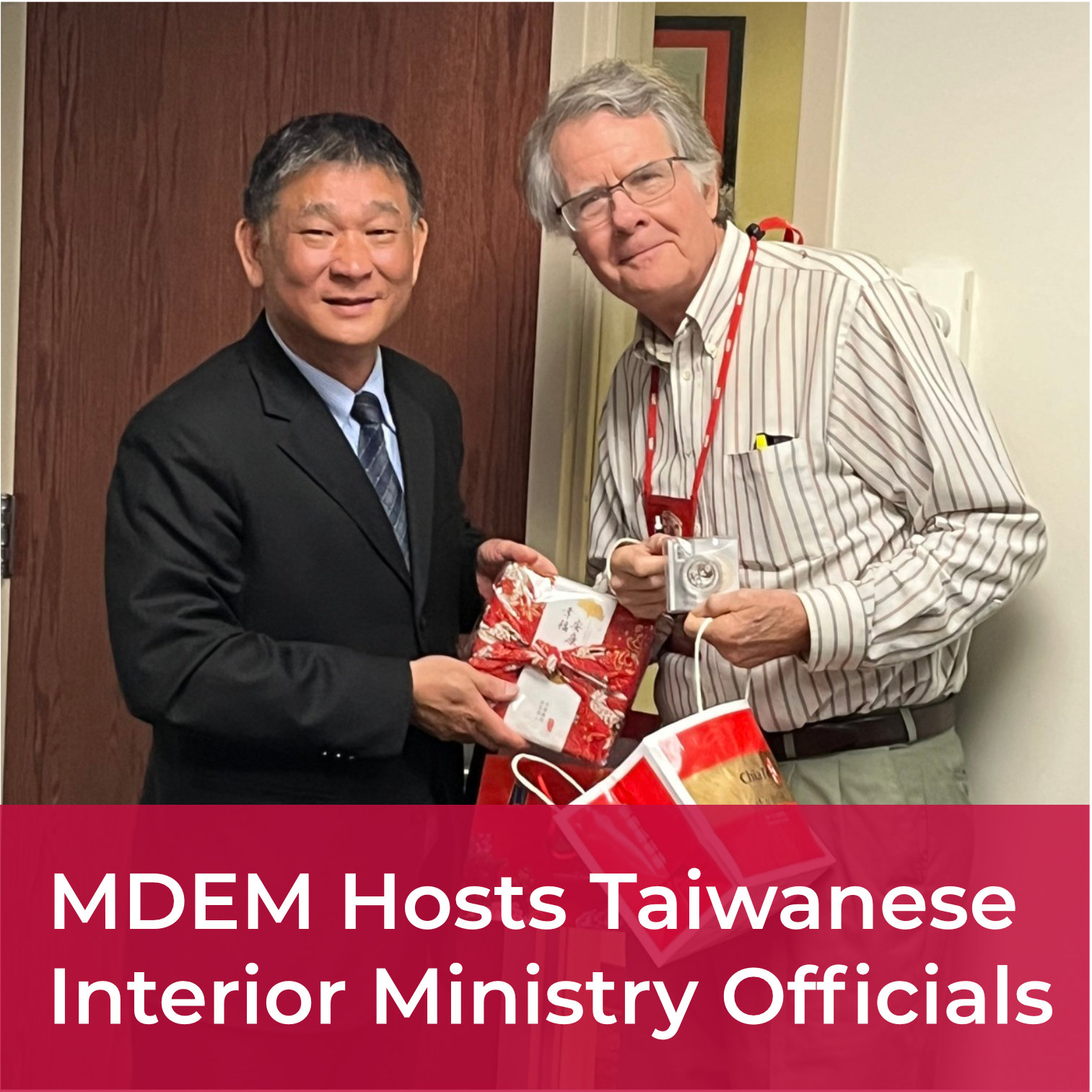 A clickable tile with the words MDEM Hosts Taiwanese Interior Ministry Officials; overlaid on a photo of officials from MDEM and the Taiwanese delegation posing with souvenirs